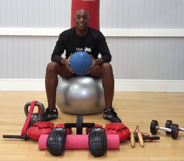 Rob personal trainer amongst his workout equipment